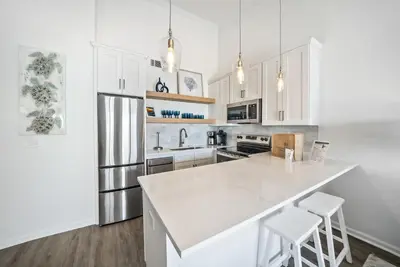 a kitchen with white cabinets and a white counter top at Leeward II 8 Sand Angels l Beachfront Condo l Newly Renovated l Beach Towels in Seagrove Beach