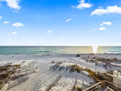 a beach with a crowd of people and the ocean at Leeward II 8 Sand Angels l Beachfront Condo l Newly Renovated l Beach Towels in Seagrove Beach