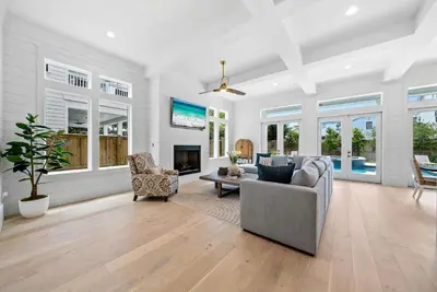 a living room with a couch and a fireplace at Magnolia Tides l 6 Bedroom l Private Pool l South of 30A l Santa Rosa Beach in Santa Rosa Beach