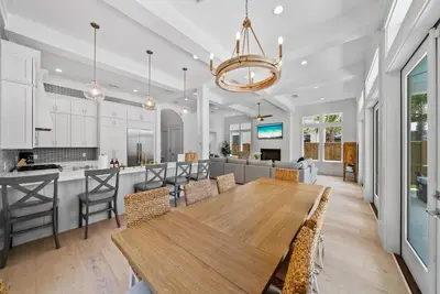 a kitchen and dining room with a wooden table and chairs at Magnolia Tides l 6 Bedroom l Private Pool l South of 30A l Santa Rosa Beach in Santa Rosa Beach