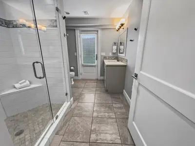 a bathroom with a shower and a sink at Nifty Shades of Gray l Beachfront and panoramic Views l Fire pit beachside l 4 Bikes in Inlet Beach