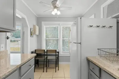 a kitchen with a white refrigerator and a table at 19224 Delmar Dr in Panama City Beach