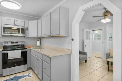 a kitchen with white cabinets and a stove top oven at 19224 Delmar Dr in Panama City Beach