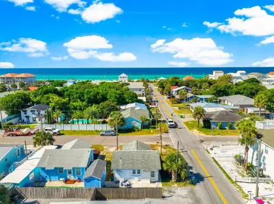 an aerial view of a small town with houses and the ocean at 19224 Delmar Dr in Panama City Beach