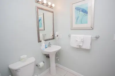 a white bathroom with a sink and a toilet at Splash 1701E - 2BD in Panama City Beach
