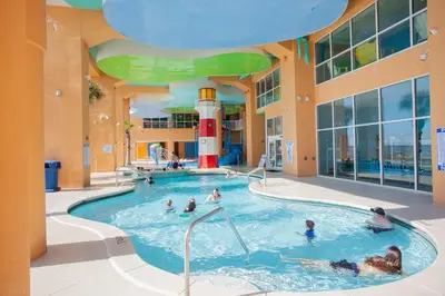 a group of people in a pool in a building at Splash 1701E - 2BD in Panama City Beach