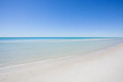 a sandy beach with the ocean in the background at Splash 1701E - 2BD in Panama City Beach