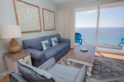 a living room with a couch and a table at Splash 1701E in Panama City Beach