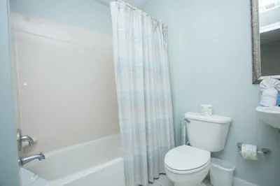 a bathroom with a toilet and a shower curtain at Splash 1701E in Panama City Beach