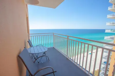 a balcony with a table and chairs and the ocean at Splash 1701E in Panama City Beach