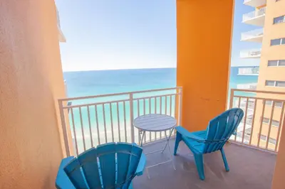two chairs and a table on a balcony with the ocean at Splash 1701E - Studio in Panama City Beach