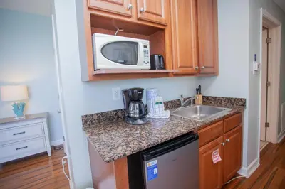 a kitchen with a sink and a microwave at Splash 1701E - Studio in Panama City Beach