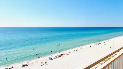 a group of people on a beach with the ocean at Splash 504E in Panama City Beach