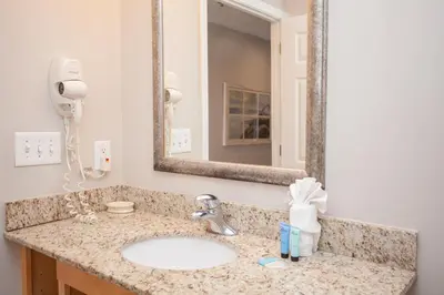 a bathroom with a sink and a mirror at Splash 504E in Panama City Beach