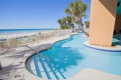 a swimming pool at the beach with the ocean in the background at Splash 504E in Panama City Beach