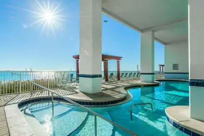 a swimming pool with the beach in the background at Majestic Beach Towers One 1314 by Emerald Coast Retreats in Panama City Beach