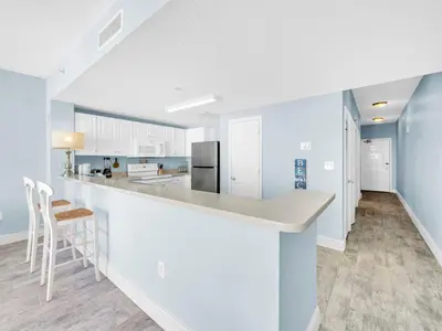 a kitchen with white cabinets and a counter top at Majestic Beach Towers One 1314 by Emerald Coast Retreats in Panama City Beach