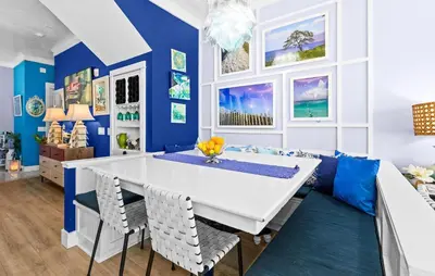 a dining room with a white table and blue walls at Memories at the Seashore in Panama City Beach