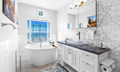 a bathroom with a tub and a sink and a mirror at Memories at the Seashore in Panama City Beach