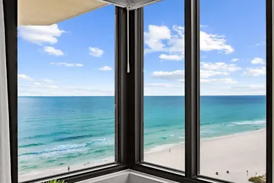 a window view of the beach from a condo at Modern Condo! Free Beach Chairs & Pools by Dolce Vita Getaways PCB in Panama City Beach