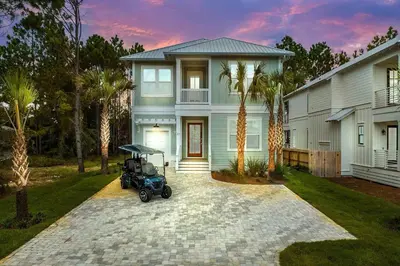 a house with a golf cart parked in front of it at Golf Cart, Big pool, Bikes, Pets OK, Walk 2 Beach! in Santa Rosa Beach