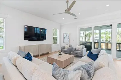 a living room with two couches and a flat screen tv at Golf Cart, Big pool, Bikes, Pets OK, Walk 2 Beach! in Santa Rosa Beach