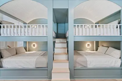 two bunk beds and a bed in a room at Golf Cart, Big pool, Bikes, Pets OK, Walk 2 Beach! in Santa Rosa Beach