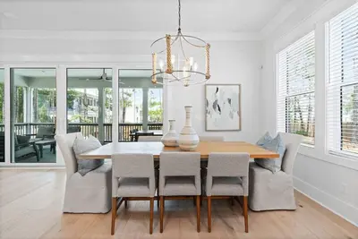 a dining room with a table and chairs at Golf Cart, Big pool, Bikes, Pets OK, Walk 2 Beach! in Santa Rosa Beach