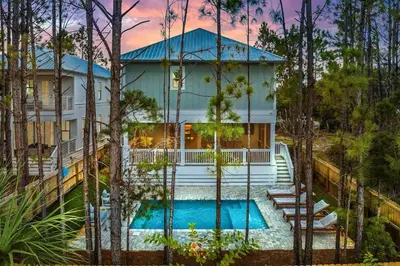 an aerial view of a house with a swimming pool at Golf Cart, Big pool, Bikes, Pets OK, Walk 2 Beach! in Santa Rosa Beach