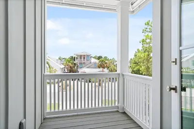 a balcony with a view of the ocean at Golf Cart, Big pool, Bikes, Pets OK, Walk 2 Beach! in Santa Rosa Beach