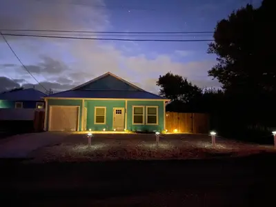 a house with lights in front of it at night at Livin Laguna Loca in Panama City Beach