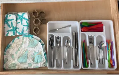 a plastic tray with utensils on a wooden shelf at Livin Laguna Loca in Panama City Beach