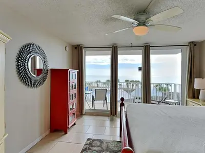 a bedroom with a bed with a ceiling fan at Dunes of Panama #B301 in Panama City Beach