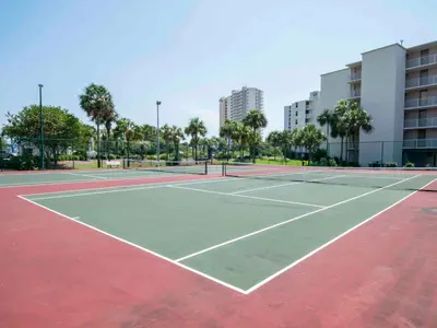 a tennis court in a city with buildings at Dunes of Panama #D702 in Panama City Beach