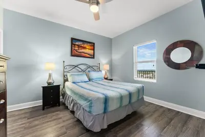 a bedroom with a bed and a window at 3 BD Gulf View Resort Condo! 5 Pools! Beach Access by Dolce Vita Getaways in Panama City Beach