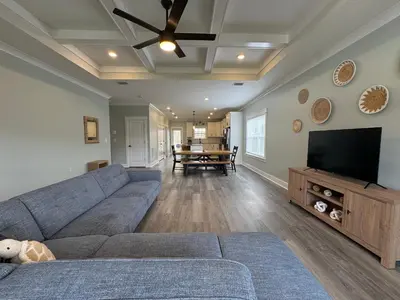 a living room with a couch and a flat screen tv at BeaLake House in Panama City Beach