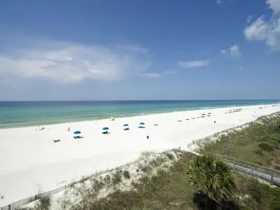 an overhead view of a beach with umbrellas at Reverie Riviera in Panama City Beach
