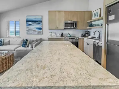 a kitchen with a large counter top in a room at Leeward II 9 l Beachfront Corner Condo l Views of the Water l Sunset Views in Seagrove Beach