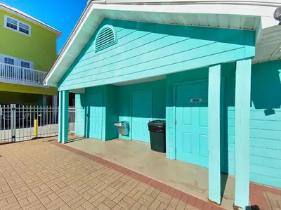 a blue building with a toilet in it at Paradise by the Pier l Ocean Views l Dog Friendly l Steps to Pier Park Shopping and Restaurants in Panama City Beach
