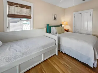 a bedroom with two beds and a window at Mare e Sole l Steps to the Beach l South of 30A l Beachfront Pool l 2 Bikes included in Rosemary Beach
