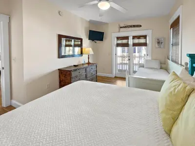 a bedroom with a bed and a dresser at Mare e Sole l Steps to the Beach l South of 30A l Beachfront Pool l 2 Bikes included in Rosemary Beach