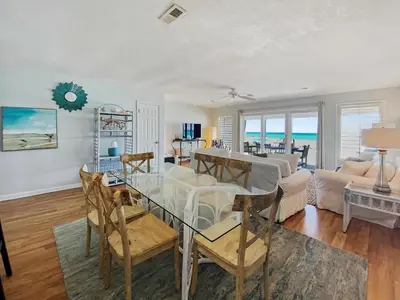 a living room with a glass table and chairs at On the Beach l Beach Front l Steps to the Beach l 2 Bikes Included in Inlet Beach