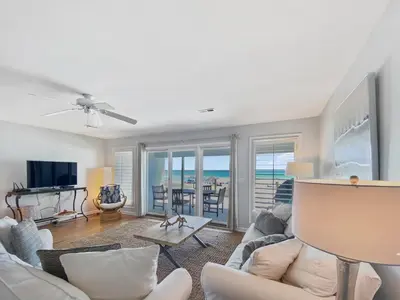 a living room with a couch and a tv at On the Beach l Beach Front l Steps to the Beach l 2 Bikes Included in Inlet Beach