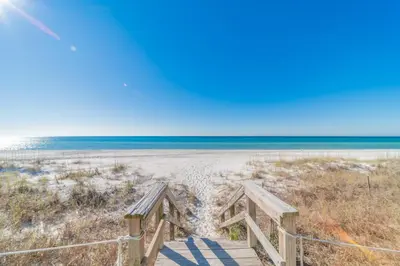 a boardwalk to the beach with the ocean in the background at On the Beach l Beach Front l Steps to the Beach l 2 Bikes Included in Inlet Beach