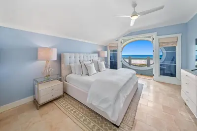 a bedroom with a large bed with a view of the ocean at Paradise Loft l Luxury Beach Front Condo l Amazing Views in Santa Rosa Beach