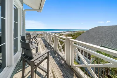 a balcony with two chairs and the beach at Paradise Loft l Luxury Beach Front Condo l Amazing Views in Santa Rosa Beach