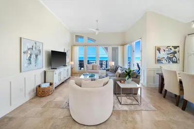 a living room with a couch and a table at Paradise Loft l Luxury Beach Front Condo l Amazing Views in Santa Rosa Beach