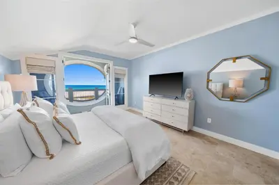 a bedroom with a large bed and a television at Paradise Loft l Luxury Beach Front Condo l Amazing Views in Santa Rosa Beach
