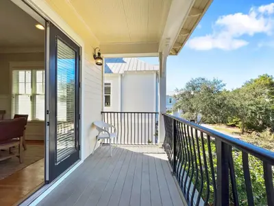 a balcony with a view of a house at Pompano Palace l Bike or Walk to Rosemary l Gulf Views l Community Pool in Rosemary Beach