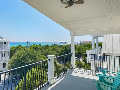 a balcony with a view of the ocean at Pompano Palace l Bike or Walk to Rosemary l Gulf Views l Community Pool in Rosemary Beach